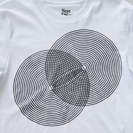 White modular synth t-shirt featuring a black concentric circle optical illusion graphic on the front, with the brand name 'Son of Sine' printed inside the collar.