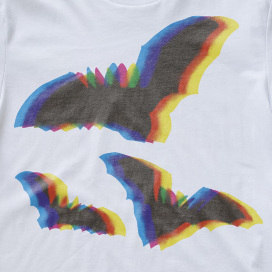 An electronic music T-shirt featuring three stylized bat wing graphics in a rainbow gradient, with the largest bat graphic on the chest and two smaller ones below.