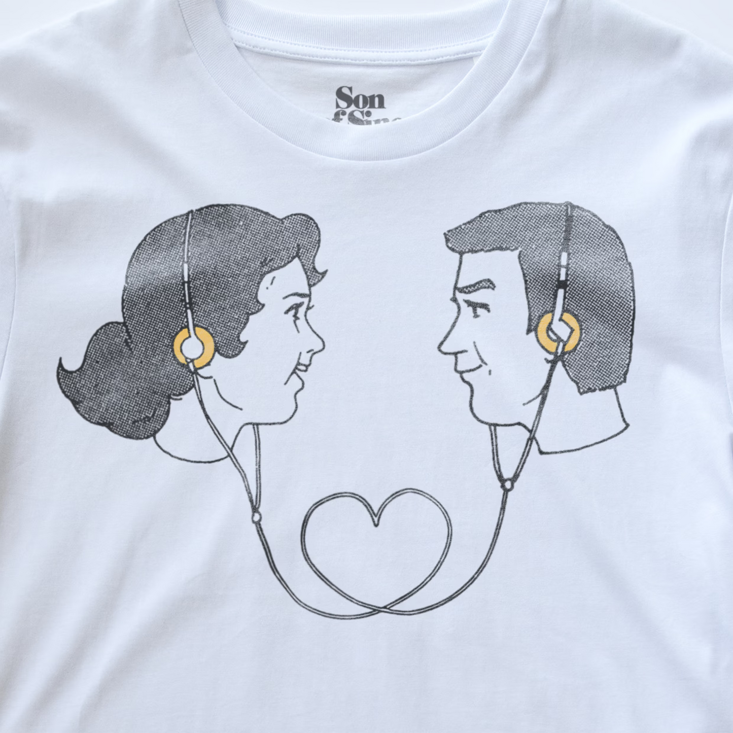 White electronic music t-shirt featuring a graphic print of a retro couple in profile facing each other, wearing headphones that form a heart shape with the earphones.