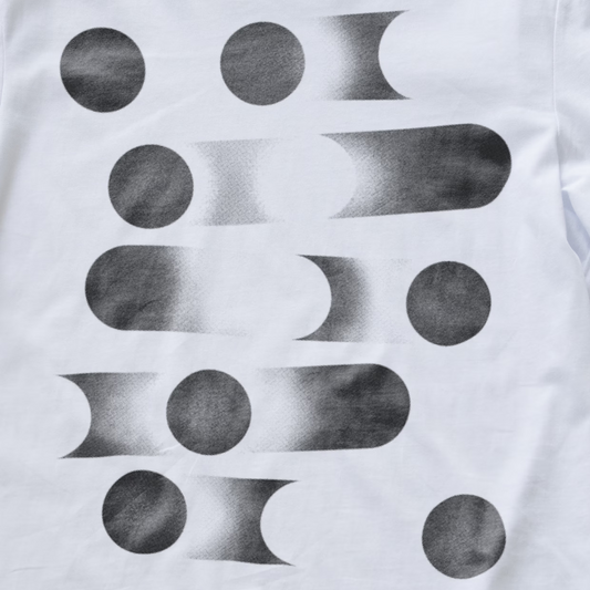 White modular synth t-shirt featuring a black and gray abstract geometric pattern of circles and elongated oval shapes with a textured, studded print.