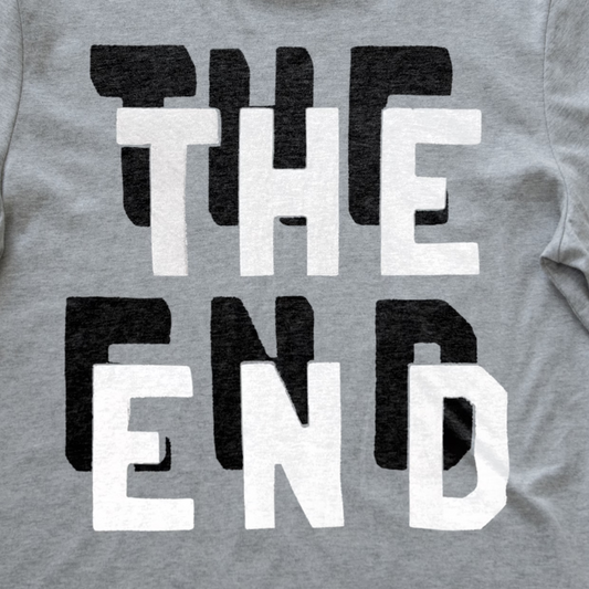 Close-up of a heather gray synth t-shirt featuring a bold graphic print that reads 'THE END' in alternating black and white block letters.
