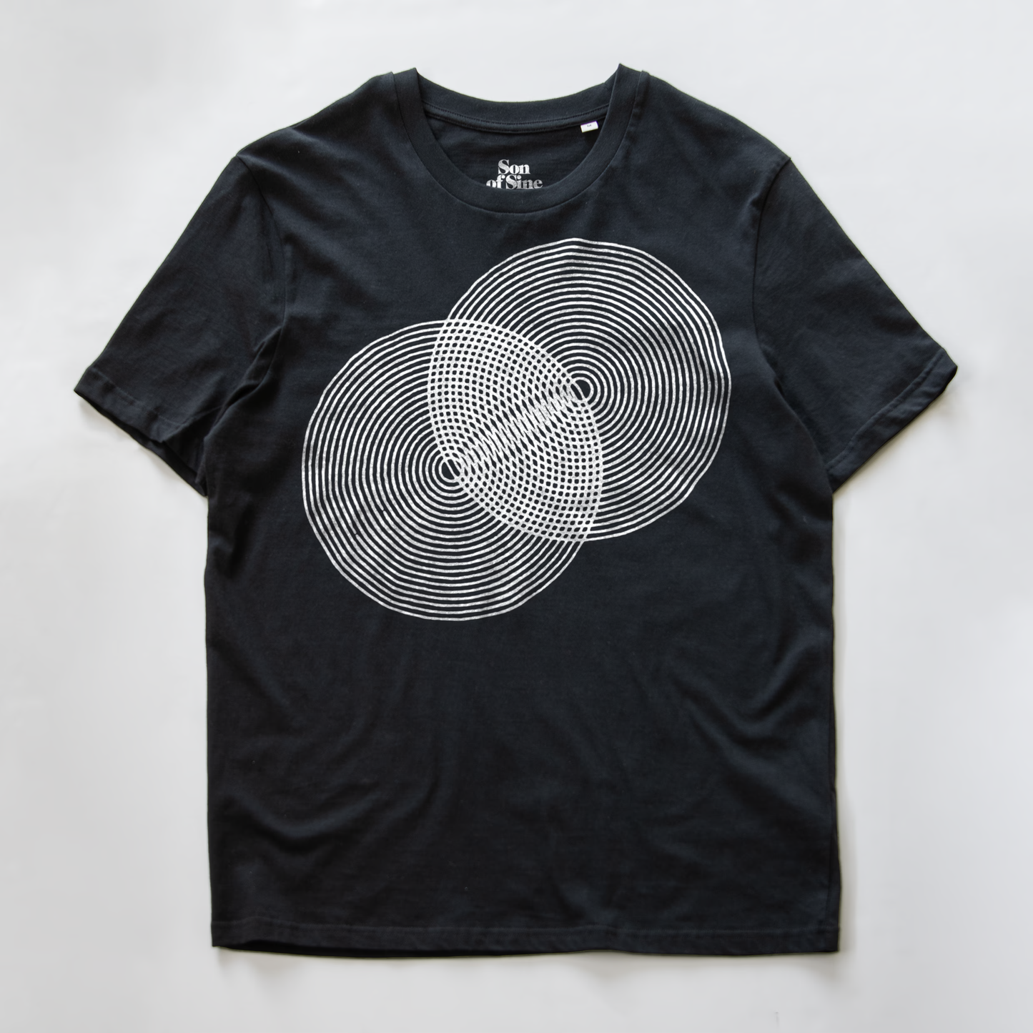 A black modular synth t-shirt with a white graphic of two overlapping circles made of concentric dotted and solid lines.