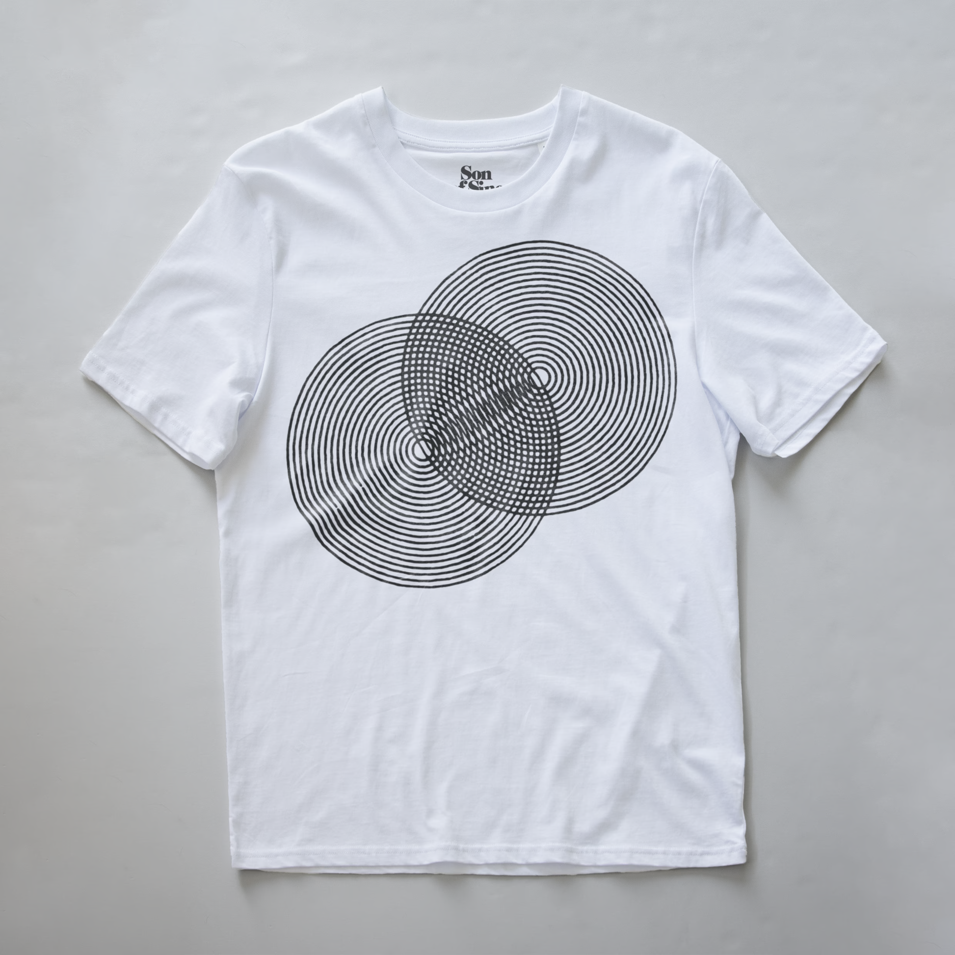 A white modular synth t-shirt with a black concentric circle graphic on the front. The brand name 'Son of Sine' is printed inside the collar.