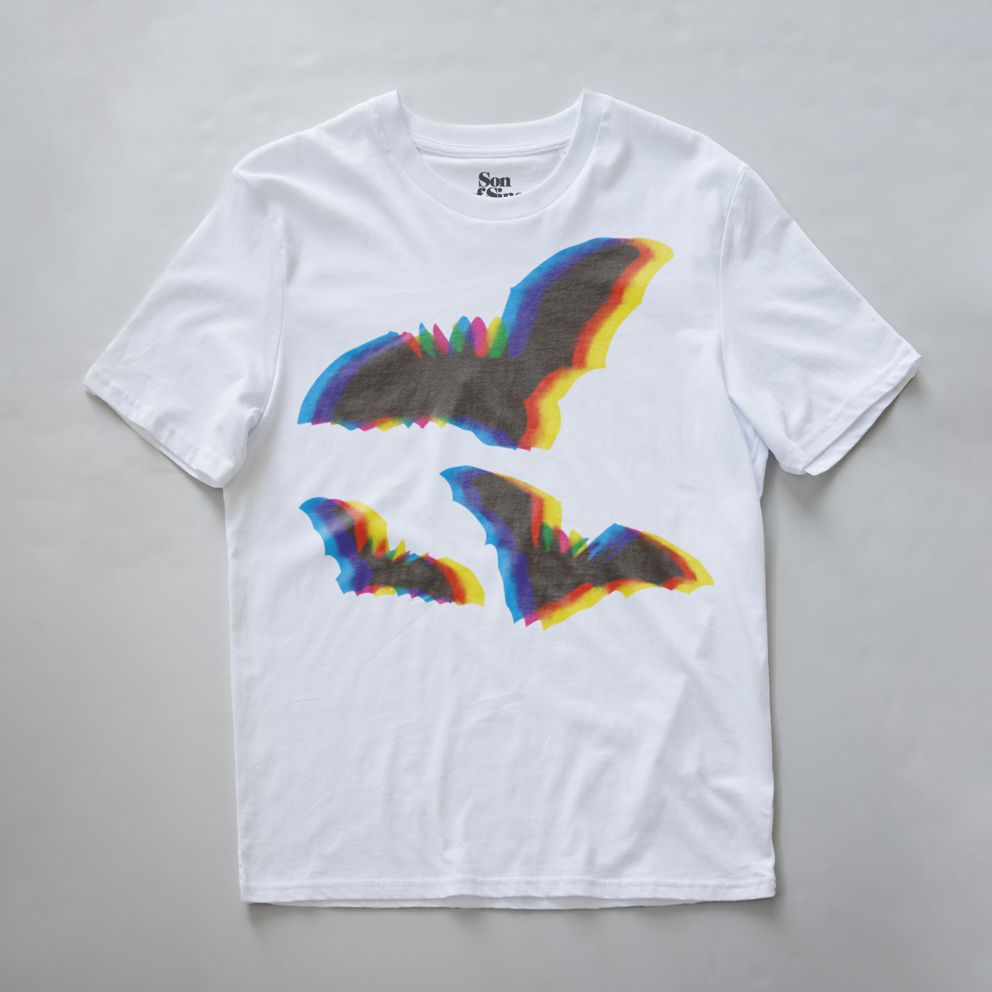 An electronic music t-shirt with a graphic print of two bats in the center, featuring a rainbow chromatic aberration effect.The inner neck label shows the brand 'Son of Sine'.