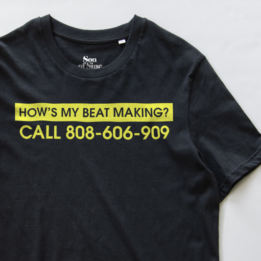 A close up of a synth inspired t-shirt with a yellow graphic text reading 'HOW'S MY BEAT MAKING? CALL 808-606-909'. The inner collar shows the brand 'Son of Sine'.