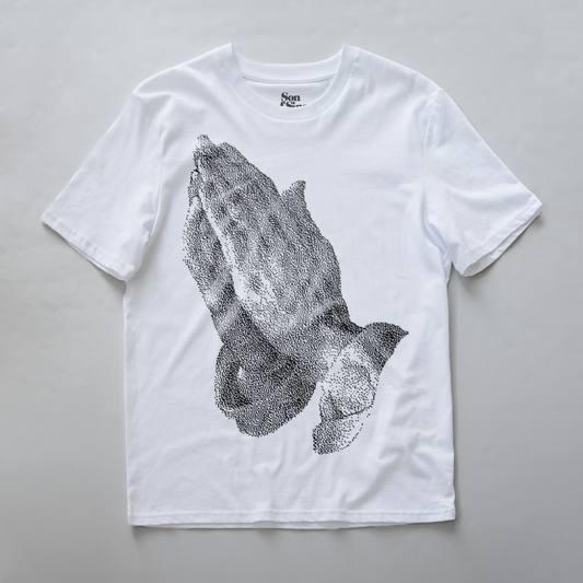 A white synth t-shirt featuring a large black digital bitmap graphic of praying hands on the front.