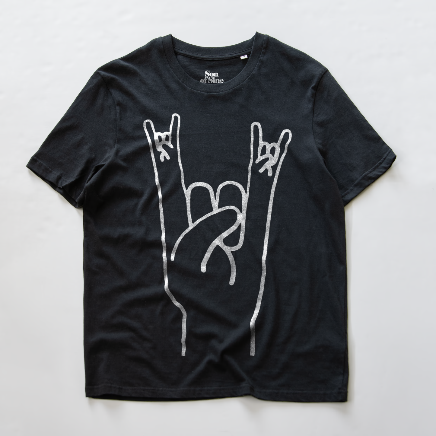 A black electronic music festival t-shirt with a white graphic of a hand making the rock on  sign.