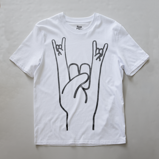 A white electronic music festival t-shirt featuring a black line art graphic of a hand making the rock on gesture.