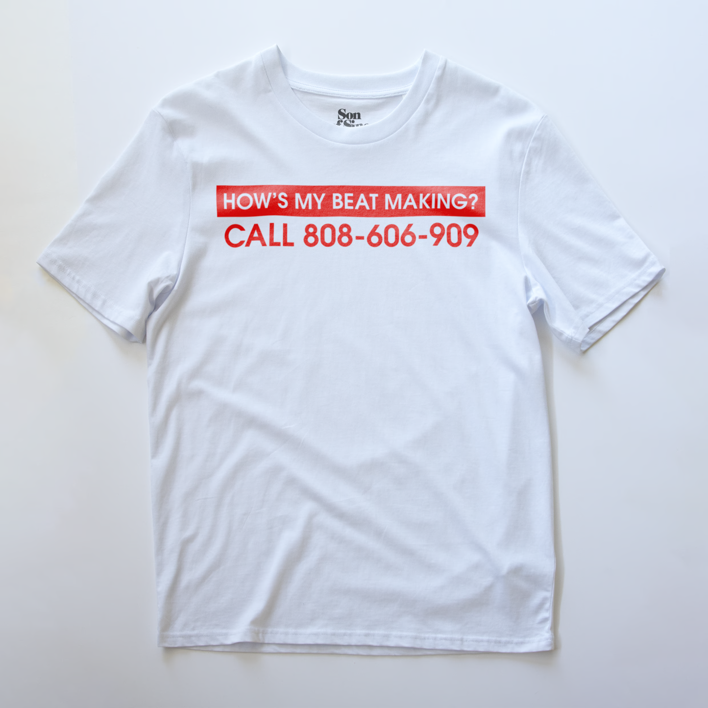 A white synth t-shirt with a red graphic text print reading 'HOW'S MY BEAT MAKING? CALL 808-606-909' on the chest.