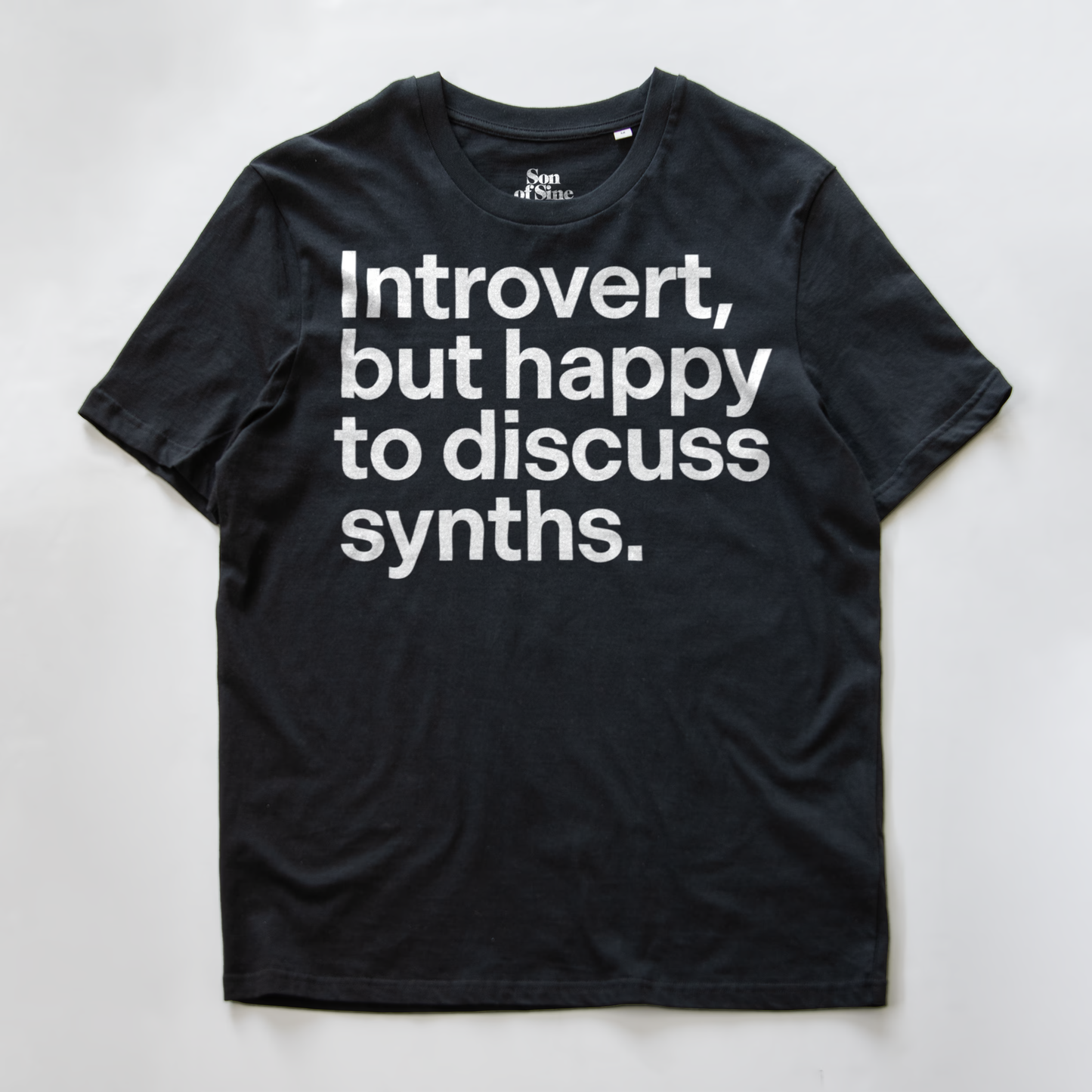 A funny synth inspired t-shirt with bold black text reading 'Introvert, but happy to discuss synths.' printed on the front.