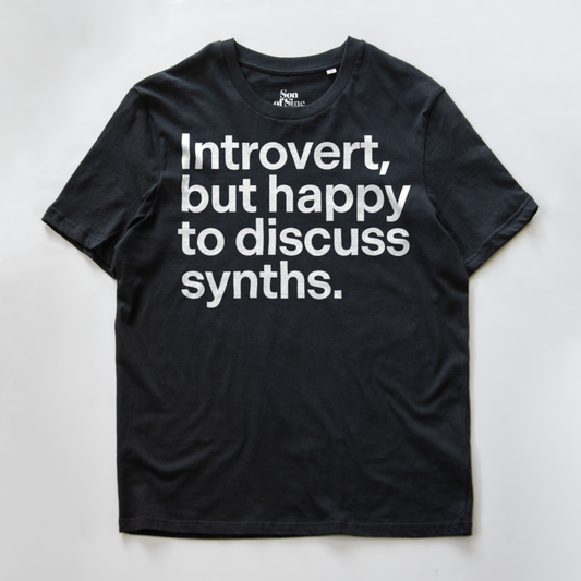 A funny synth inspired t-shirt with bold black text reading 'Introvert, but happy to discuss synths.' printed on the front.
