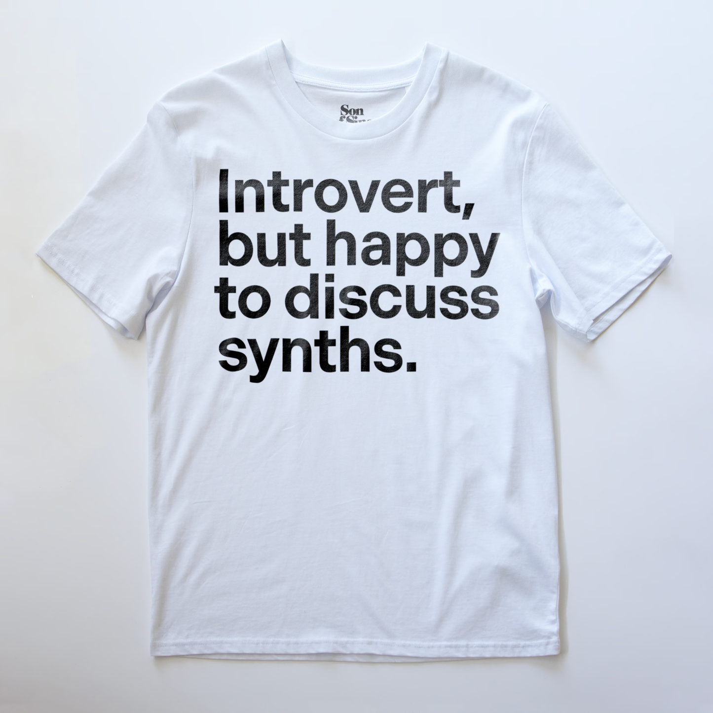 A funny synth inspired t-shirt with bold black text reading 'Introvert, but happy to discuss synths.' printed on the front.