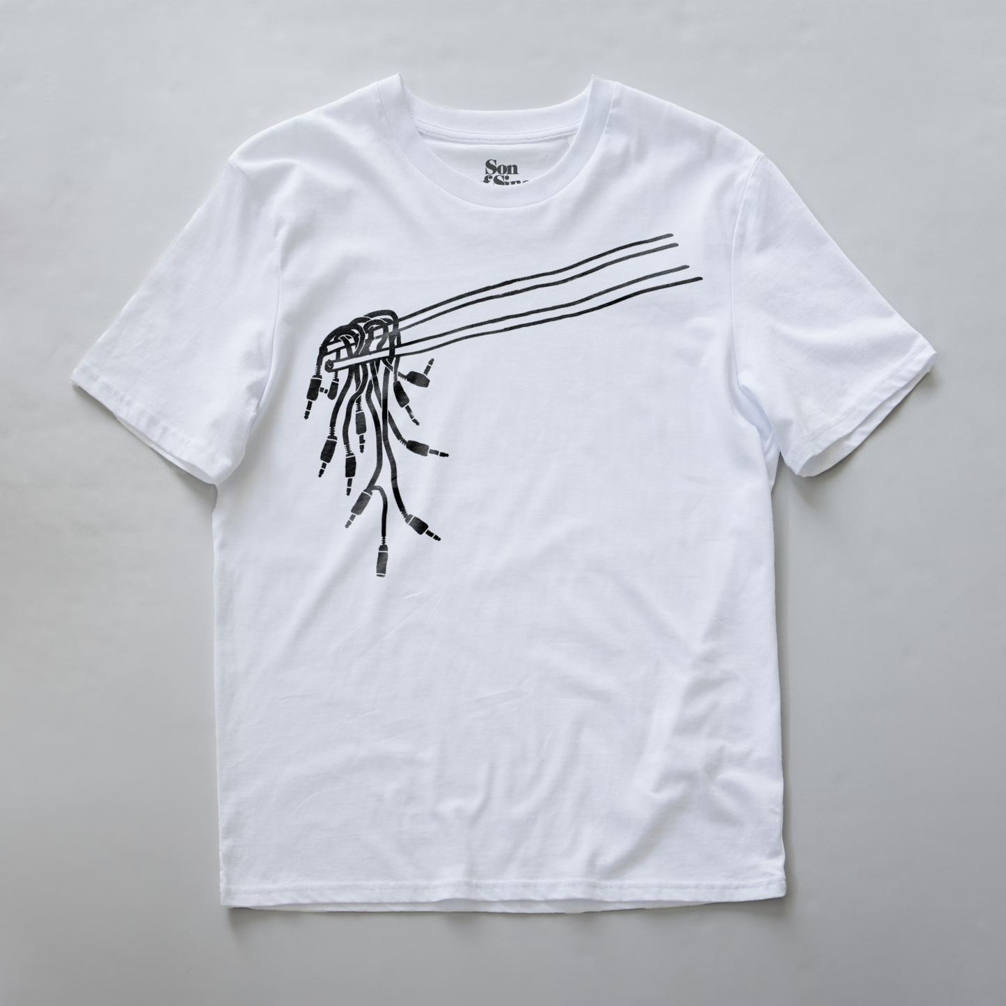 A modular synth t-shirt with a black line art graphic of chopsticks holding patching cables used for modular synths.
