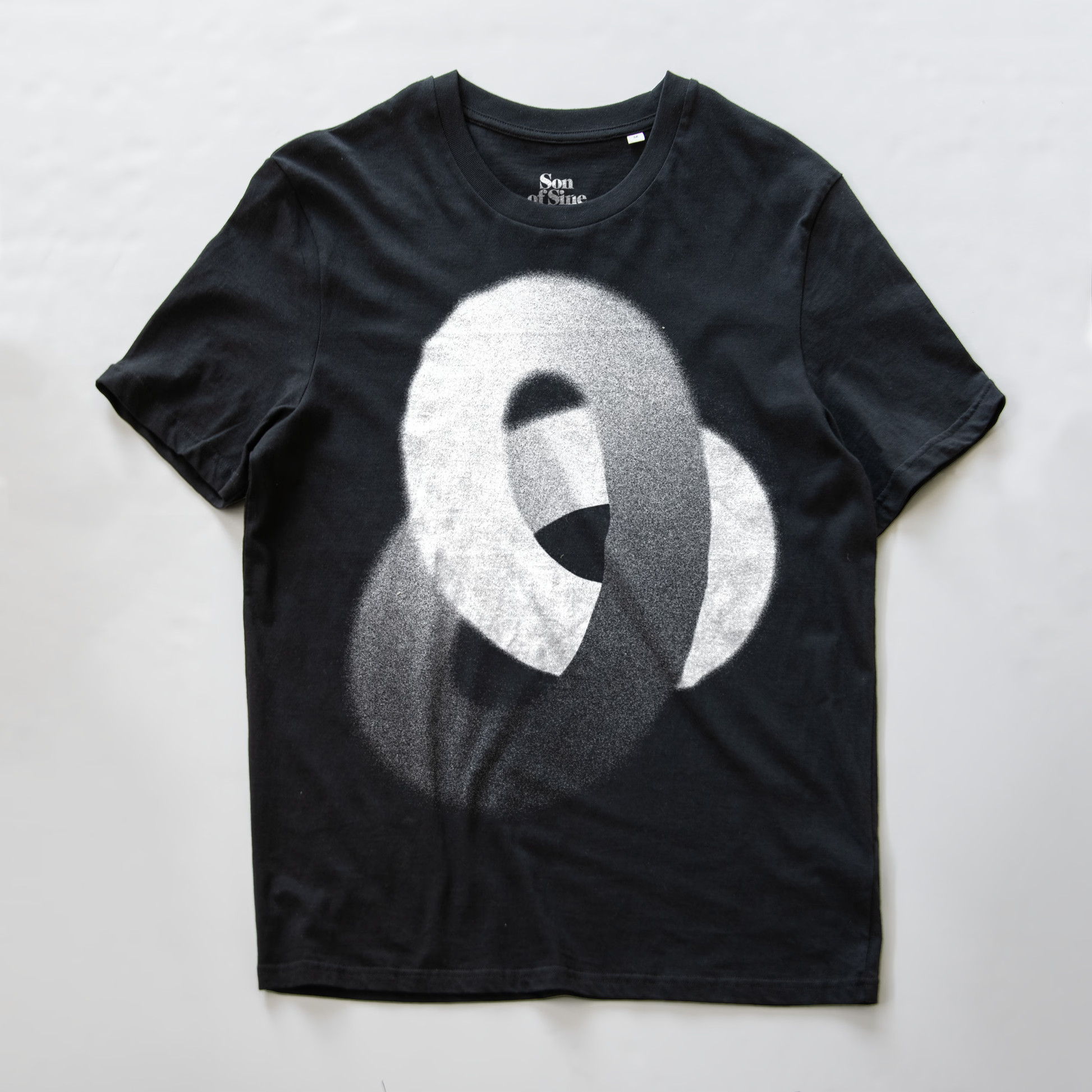 A black synth inspired t-shirt featuring a large, textured white and gray abstract knot-like graphic on the front.