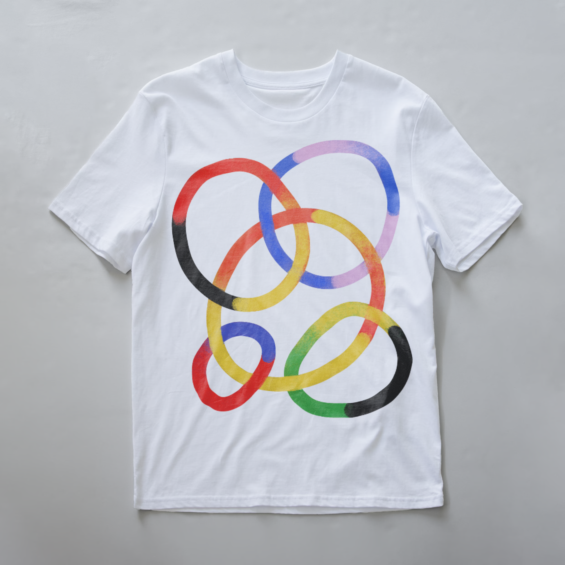 A white electronic music festival t-shirt featuring a graphic of overlapping watercolor-style rings in red, yellow, blue, purple, green, and black.