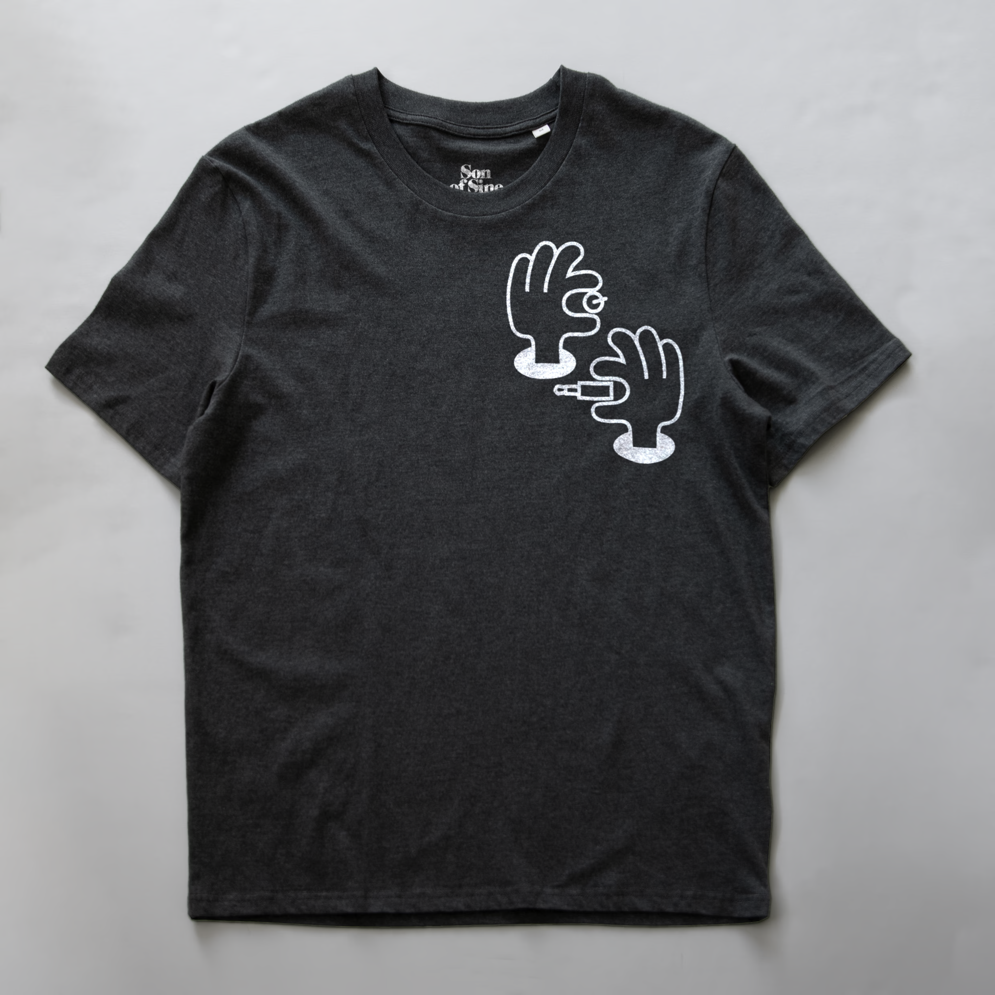 A dark heather gray synth inspired t-shirt with a white graphic illustration of two hands patching and tweaking electronic music.