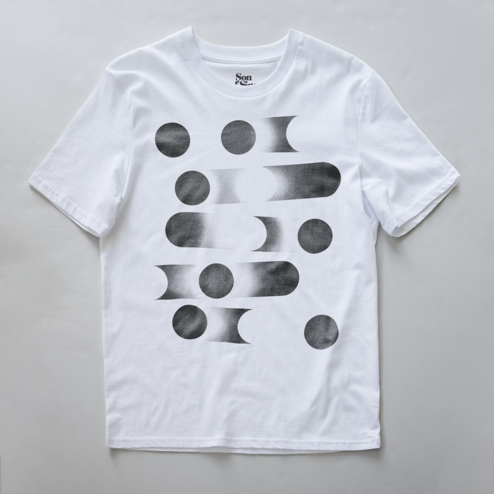 A white modular synth t-shirt with a black geometric abstract print of circles and gradient bars on the front.