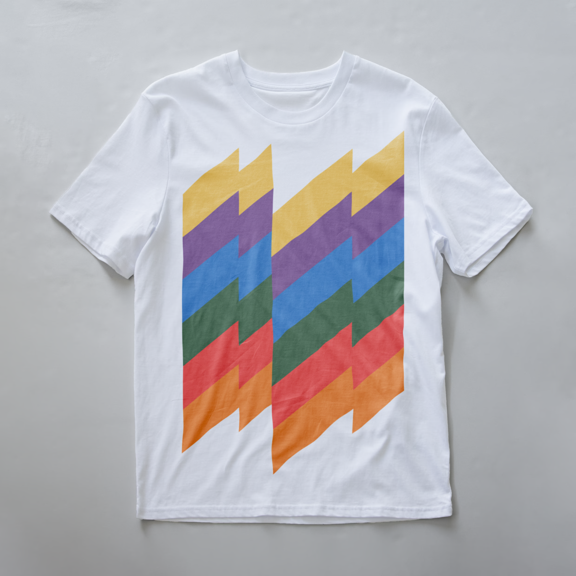A white modular synth t-shirt with a retro graphic print of vertical zigzag stripes in yellow, purple, blue, green, red, and orange.