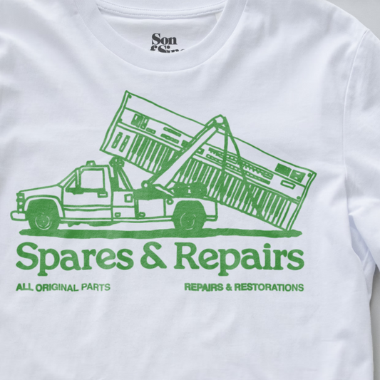 White synth inspired t-shirt featuring a green graphic of a tow truck lifting a synth, with the text 'Spares & Repairs' and 'ALL ORIGINAL PARTS' 'REPAIRS & RESTORATIONS' printed below.