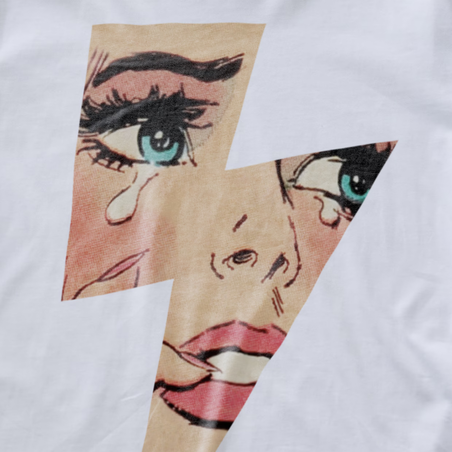 A close up of a white electronic music t-shirt with a graphic print of a lightning bolt revealing a comic book styled image of a crying woman's face. 