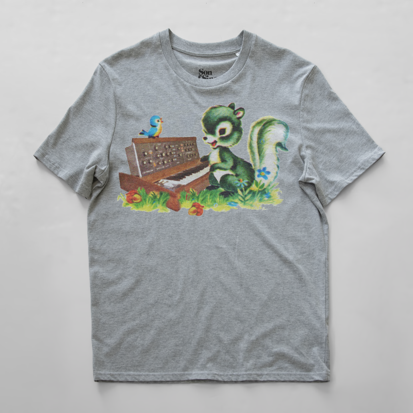 A heather gray synth t-shirt with a colorful graphic print of a green squirrel playing a minimoog synth and a small blue bird perched on top.