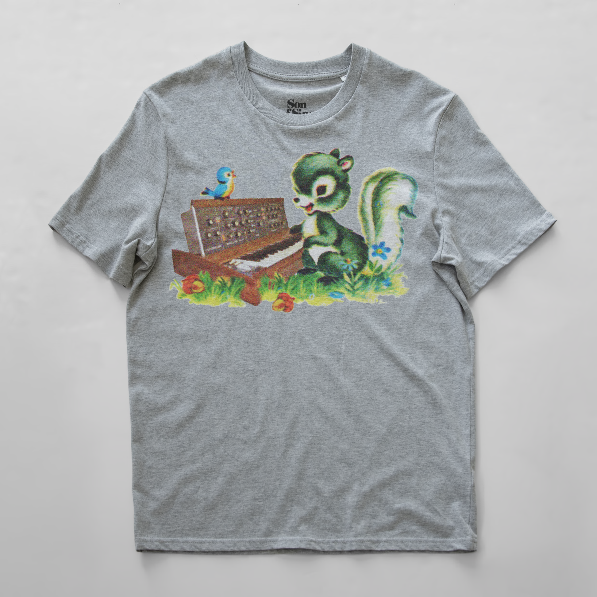 A heather gray synth t-shirt with a colorful graphic print of a green squirrel playing a minimoog synth and a small blue bird perched on top.